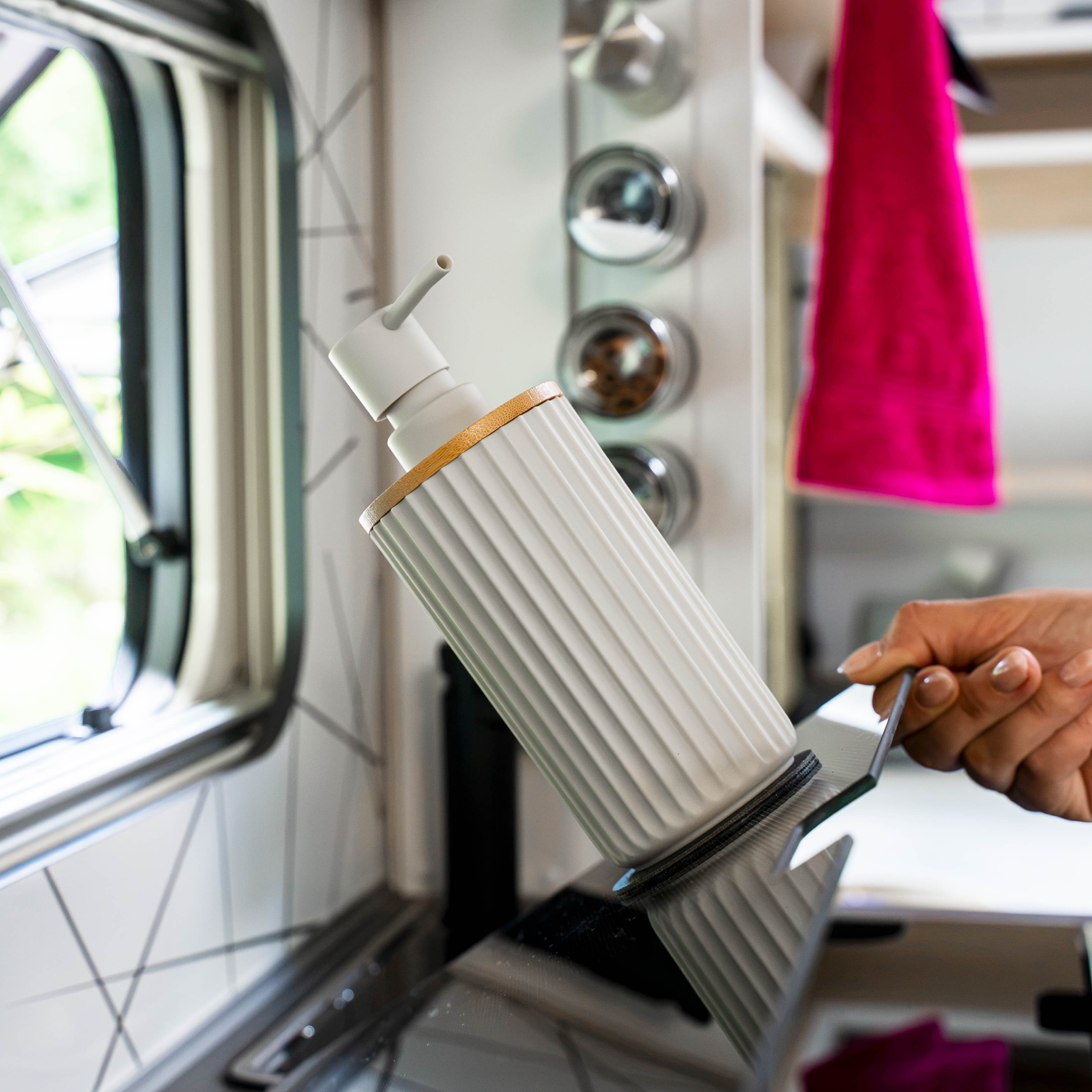 Magnetic soap dispenser and magnetic toothbrush cup including pads